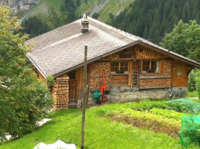 Gimmelwald House Surrounded by Cut Wood 